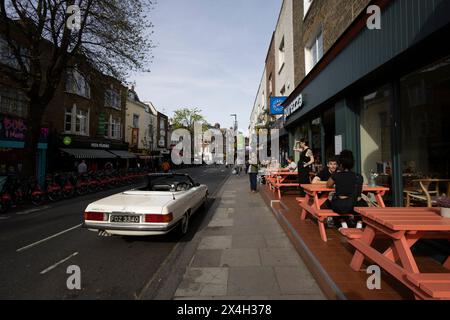 Classic Merecedes 350 SEL sits on the Camden Town roadside in hip North London, England, United Kingdom Stock Photo