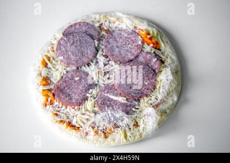 Frozen semi-finished pizza from the supermarket. Fast food concent Stock Photo