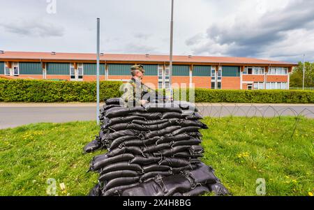 27 April 2024, Hesse, Alsfeld: Bundeswehr soldiers sit in an armored ...