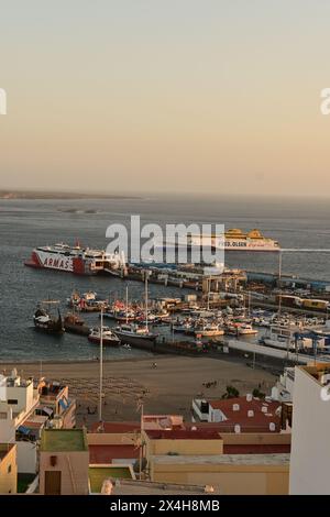 A tranquil view of a harbor with docked ferries and boats under a clear ...
