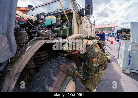 27 April 2024, Hesse, Alsfeld: Bundeswehr soldiers sit in an armored ...