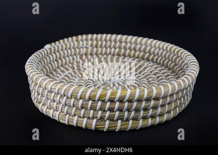vintage weave wicker basket isolated on black background. handicrafted eco friendly flower or fruit busket. Stock Photo
