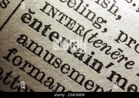 Word entertain on dictionary page, macro close-up Stock Photo
