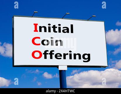 ICO initial coin offering symbol. Concept words ICO initial coin offering on beautiful big billboard. Beautiful blue sky cloud background. Business IC Stock Photo