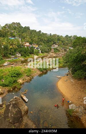 Indian people washing clothes in the Periyar River, Mundakayam, Kerala, India Stock Photo