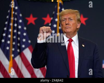 Former President Donald Trump reacts to supporters during a commit to caucus rally, Tuesday, Dec. 19, 2023, in Waterloo, Iowa. Stock Photo