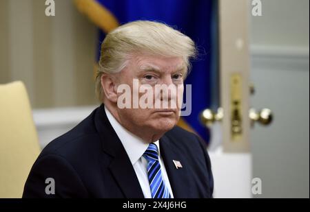 U.S President Donald Trump looks on during a meeting with South Korean President Moon Jae-in in the White House on June 30, 2017 in Washington, DC. Stock Photo