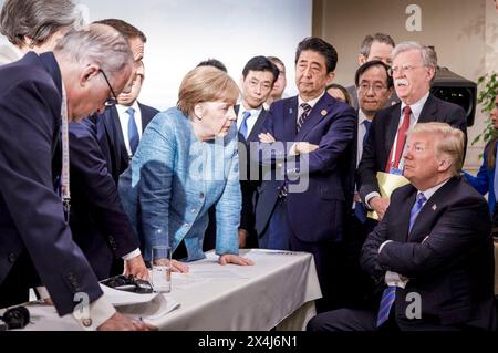 German Chancellor Angela Merkel speaks with U.S. President Donald Trump during the G7 Leaders Summit in La Malbaie, Quebec, Canada on June 9, 2018. Stock Photo