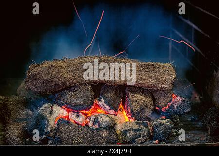 Peat fire in a whisky distillery kiln at Kilchoman distillery , Islay, Scotland Stock Photo