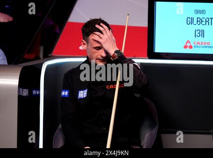 David Gilbert reacts during his semi-final match against Kyren Wilson (not pictured) on day fourteen of the 2024 Cazoo World Snooker Championship at the Crucible Theatre, Sheffield. Picture date: Friday May 3, 2024. Stock Photo
