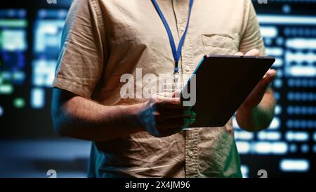 Close up of specialist in high tech facility providing secure, scalable, and reliable infrastructure for storing, processing, and analyzing large amounts of data generated by artificial intelligence Stock Photo