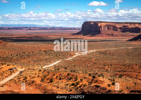 View of the long dirt road into Monumant Valley's Navajo Tribal Park shows the initial barren look of the park that quickly turns into a rock formatio Stock Photo