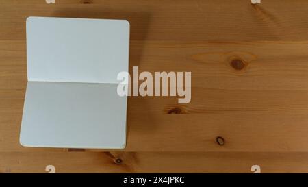 Minimalist wooden desk with blank journal, inviting inspiration and creativity Stock Photo
