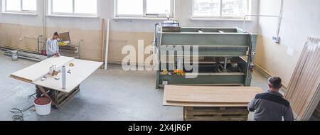 wide angle view of carpenters working in the factory, wood industry. High quality photo Stock Photo