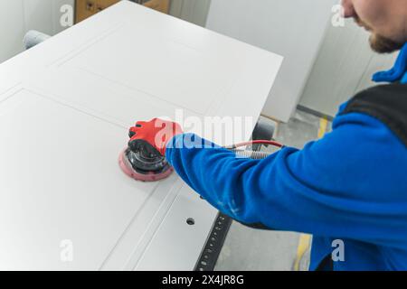 Carpenter using sander while working on a piece of wood. High quality photo Stock Photo