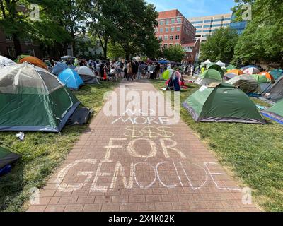 Washington, District Of Columbia, USA. 3rd May, 2024. The words 'no more $$$ for genocide' are chalked on the sidewalk at The George Washington University encampment. Tents are neatly tethered around the quad. (Credit Image: © Sue Dorfman/ZUMA Press Wire) EDITORIAL USAGE ONLY! Not for Commercial USAGE! Credit: ZUMA Press, Inc./Alamy Live News Stock Photo