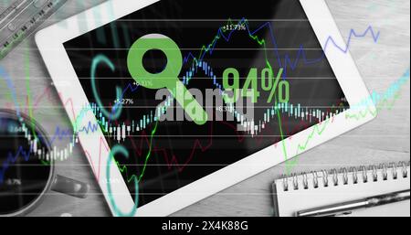 Image of financial data processing with percent growing over desk with tablet Stock Photo