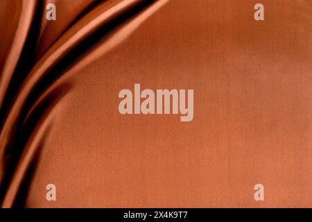 Brown orange gold elegant luxury background. Silk satin velvet fabric. Stock Photo