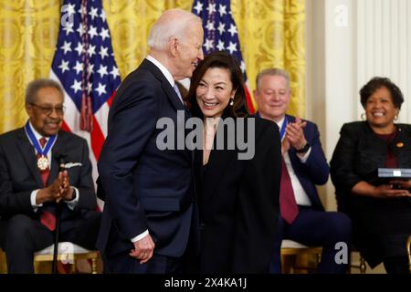 United States President Joe Biden presents actress Michelle Yeoh with the Presidential Medal of Freedom, the countrys highest civilian honor, during a ceremony in the East Room of the White House in Washington, DC on Friday, May 3, 2024. Several of todays recipients are Democratic Party stalwarts, and Biden himself was awarded the honor by former President Barack Obama in the final days of their administration in 2017. Credit: Jonathan Ernst/Pool via CNP Stock Photo