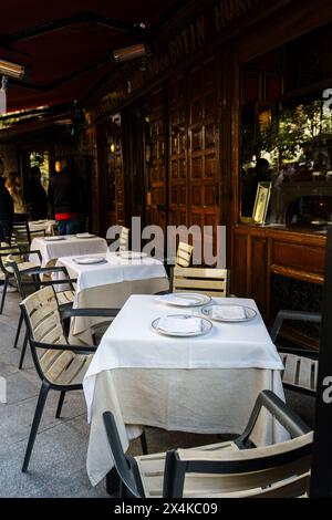 Madrid, Spain. February 11, 2024 - Tables with white tablecloths outside the restaurant Botin Stock Photo
