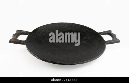 Blank cast iron pan. fish frying on a black pan. an Indian frying pan or griddle used for cooking chapattis. Stock Photo