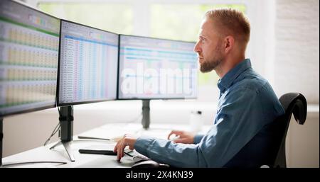 Data Analyst Man Using Spreadsheet On Computer Stock Photo