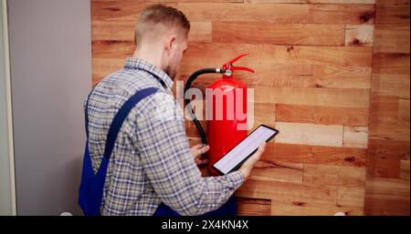 Fire Extinguisher By Handyman. Portable Extinguish Equipment Checking Stock Photo