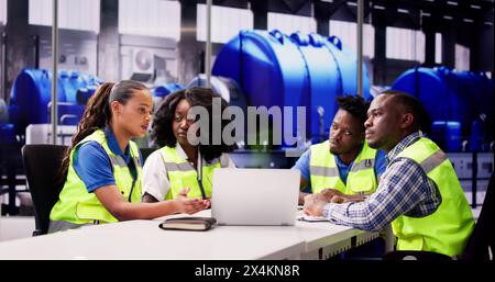 Team Of Engineers Talking At Industrial Workplace Stock Photo