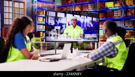 Warehouse Workers Having Video Conference With Woman Stock Photo