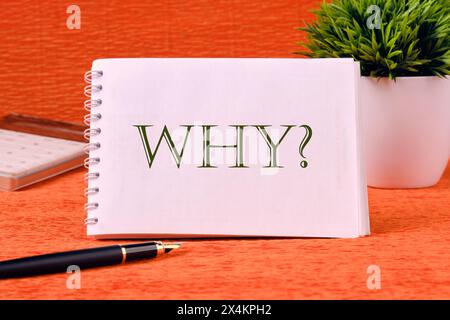 Business concept. Home Office. The Word Why written on a white notebook on an orange background Stock Photo