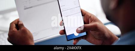 Using a phone to take picture of invoice document Stock Photo