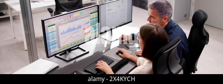 Multiple medical coders working on computer spreadsheets. Stock Photo