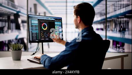 Spreadsheet Analyst Employee Using Computer Monitors For Analysis Stock Photo