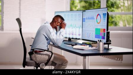 Data Analyst African Man Using Spreadsheet On Computer Stock Photo