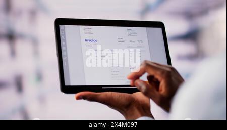 Accountant Checking Online Invoice On Tablet Screen Stock Photo