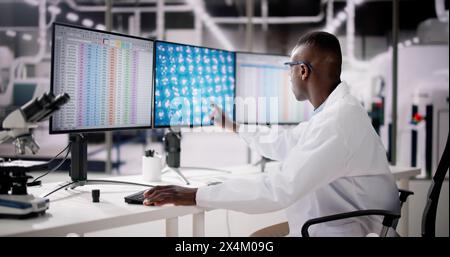 African American Analyzing Spreadsheet Data At Work Stock Photo