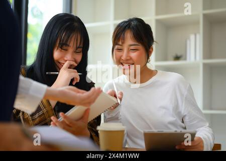 Cheerful college students working together project at library Stock Photo