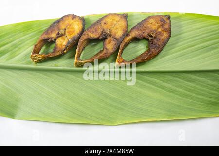 Fried Ilsha on Turmeric leaf. Hilsa fry is popular in pohela boishakh festival among Bengali's in India and Bangladesh. Ilish. Tenualosa ilish Stock Photo