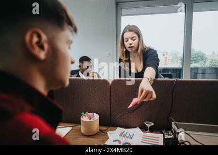 Team analyzing data during a business meeting in a modern office setting Stock Photo