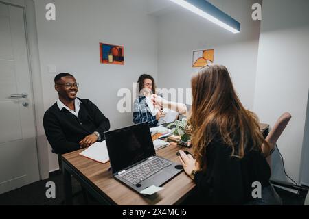 Multicultural office team discussing business growth and statistics in a modern workspace Stock Photo