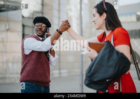 Business associates giving a high five in an urban outdoor setting Stock Photo