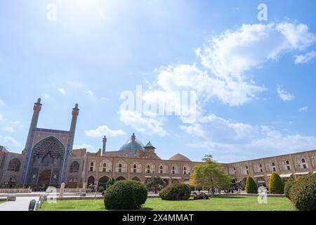 Isfahan, Iran - March 5, 2024: The entrance to the Imam Mosque is flanked by two towering minarets decorated with bright blue tiles. An atmosphere of Stock Photo