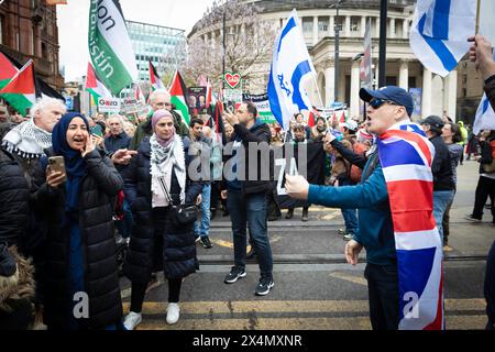 Manchester, UK. 04th May, 2024. An Israel supporter gestures and shouts at a Palestine demonstrator. Palestine movements join in solidarity for International Workers Day to raise awareness for all professionals operating in Gaza. Credit: Andy Barton/Alamy Live News Stock Photo