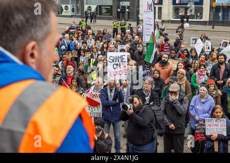 Leeds, UK. 04 MAY, 2024. Protestor holds 'Shame on Europe' Sign amongst a crowd at the May Day March for Peace, organised by the Leeds Trades Union Council. The march began from Leeds art gallery and took a route through the city with representives from different organisations bringing banners and flags. Credit Milo Chandler/Alamy Live News Stock Photo