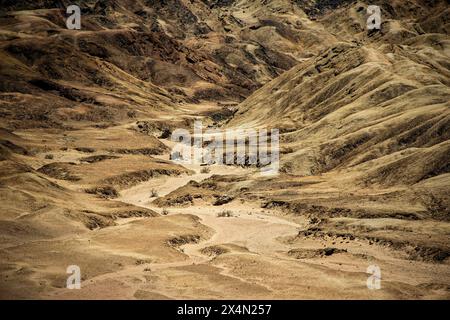 A valley threading its way through the hills of the moon landscape near Swakopmund. Stock Photo