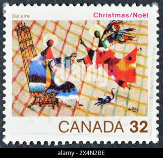 Cancelled postage stamp printed by Canada, that shows painting 'The Annunciation' by Jean Dallaire, Christmas, circa 1984. Stock Photo