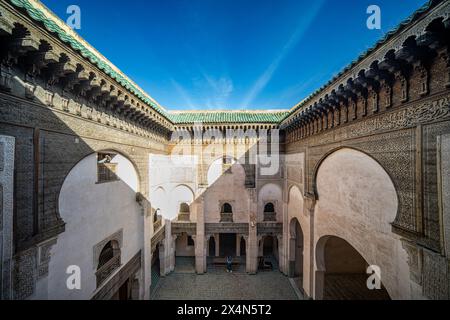 A tranquil view captures the essence of Fez through the ornate window of Cherratine Madrasa. Fez, Morocco. Stock Photo