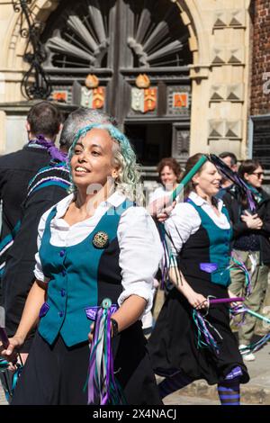 May 4th 2024. The Guildford Summerpole Festival took place in the town centre today. The annual event run by the Guildford Pilgrim Morris dancers involves a procession up the High Street, displays of morris dancing by several groups, followed by erecting the summerpole (instead of a traditional maypole) in Guildford Castle grounds, and further dancing. Customs and Exiles North West Morris dance team from Wokingham dancing outside Abbot's Hospital. Stock Photo