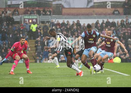 Burnley, UK. 04th May, 2024. Alexander Isak of Newcastle United in knocked off the ball by Lorenz Assignon of Burnley. Premier League match, Burnley v Newcastle Utd at Turf Moor in Burnley, Lancs on Saturday 4th May 2024. this image may only be used for Editorial purposes. Editorial use only, pic by Chris Stading/Andrew Orchard sports photography/Alamy Live news Credit: Andrew Orchard sports photography/Alamy Live News Stock Photo