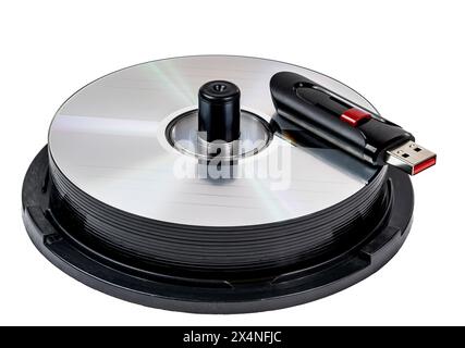 Horizontal close-up shot of a flash drive on a stack of CDs Isolated on white. Stock Photo